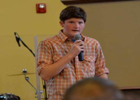 Justin reads the scriptures on his Sunday to assist in worship.